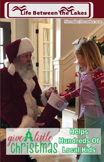 November/December 2020 cover: Santa handing a stocking to a young girl in a mermaid costume